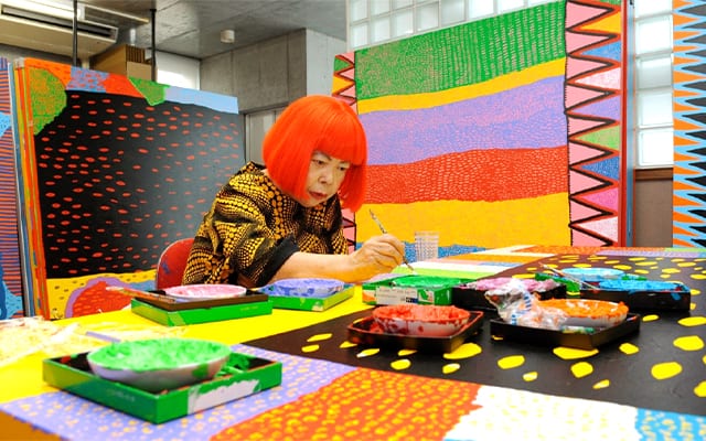 Kusama creating in her studio in 2014